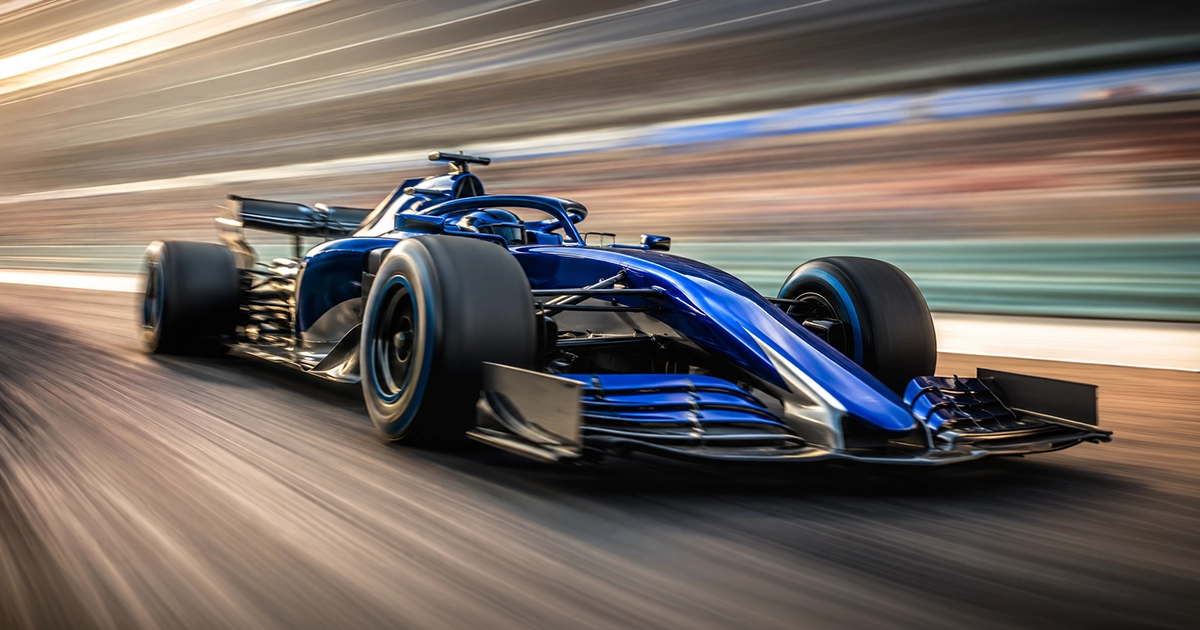 A Formula 1 car with extreme motion blur banking through a corner at high speed, conveying the pace of a sprint race