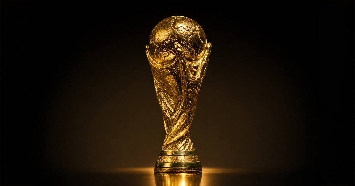 The FIFA World Cup trophy gleaming under stadium lights